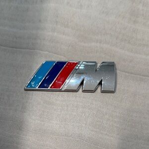 Silver and Multicolor Car Emblem